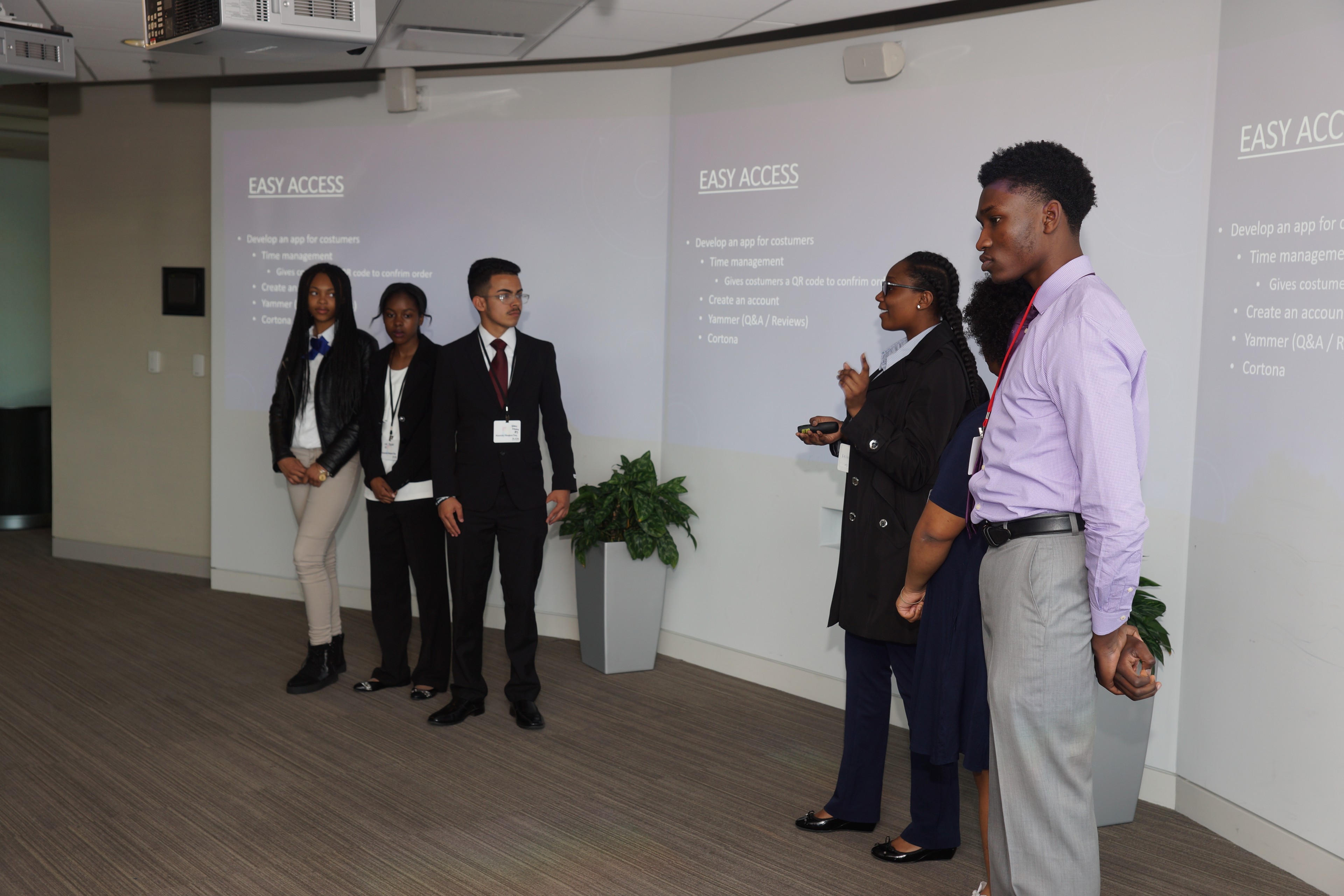High school students presenting their AI project to an audience