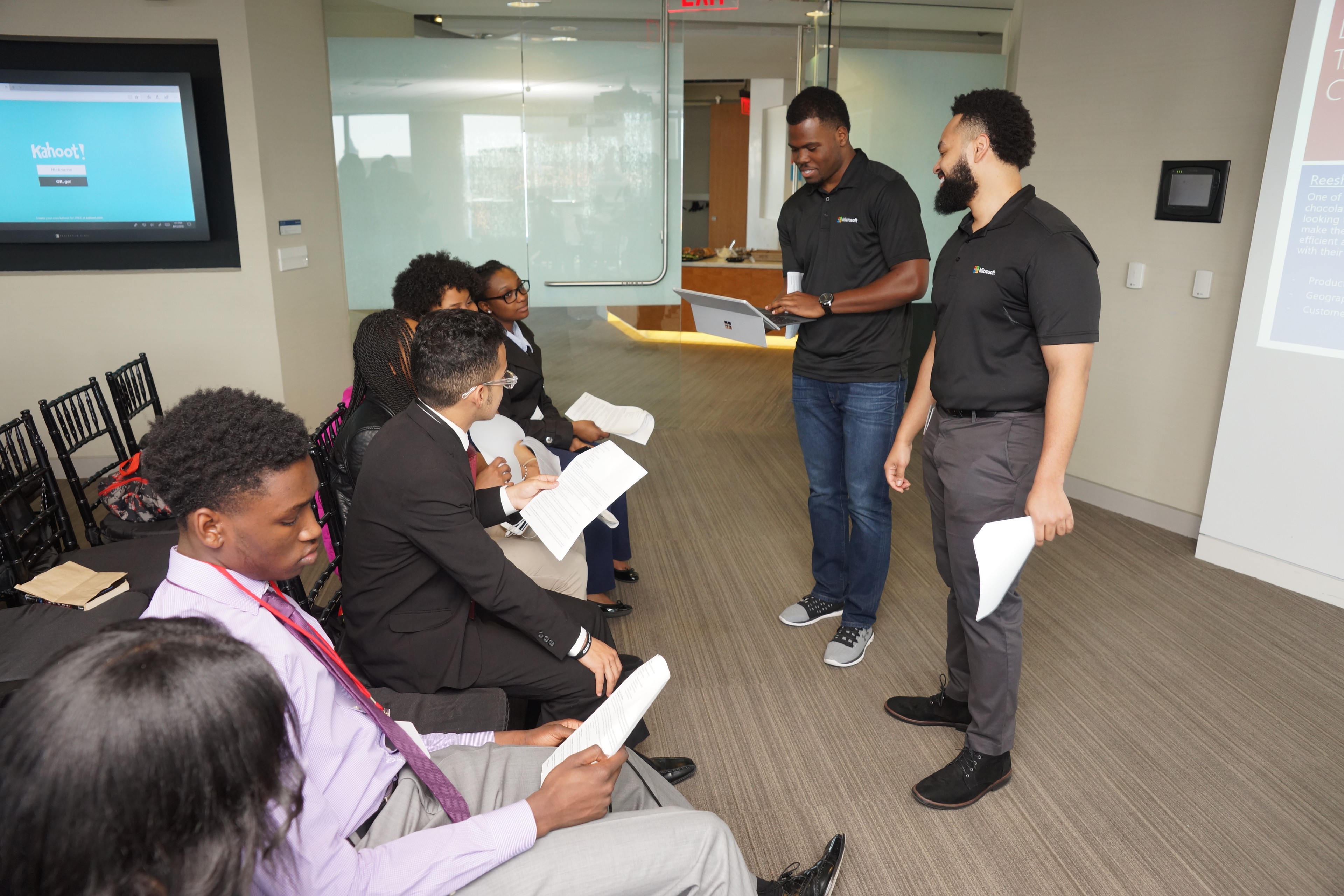 Instructors guiding high-school students during a collaborative AI and computer science workshop